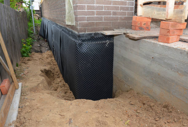 Happy homeowners after waterproofing job in Hugo